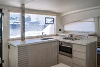 Modern kitchen interior on 2016 Leopard 40 yacht with stove, oven, and large window.