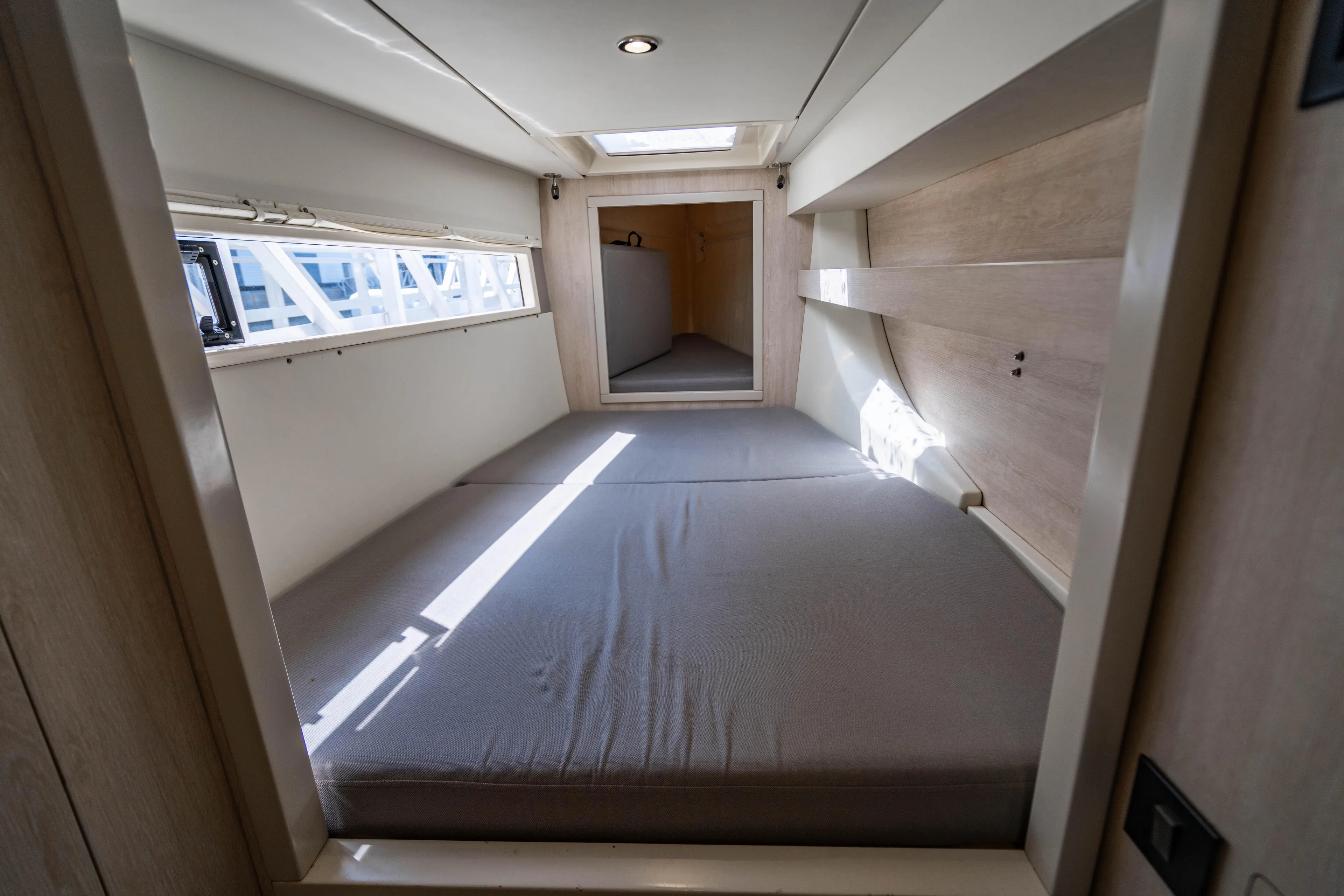 Interior cabin of 2016 Leopard 40 catamaran with bed and window.