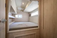 Cabin interior of 2016 Leopard 40 catamaran with bed and window.