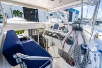 Helm of 2016 Leopard 40 catamaran with navigation equipment and ropes in marina setting.