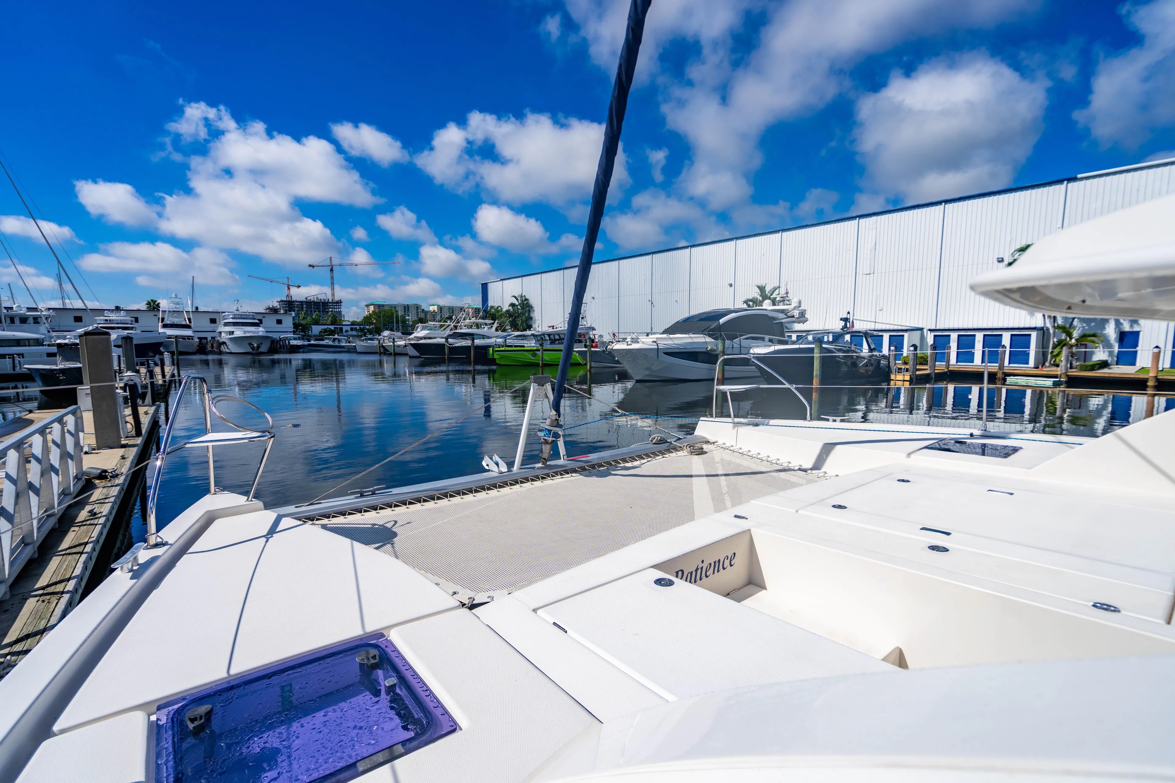 2016 Leopard 40 catamaran docked at marina under clear blue sky.