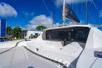2016 Leopard 40 catamaran with spacious deck, docked under clear blue skies.