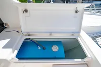 Open storage compartment on 2016 Leopard 40 boat, revealing a blue tank inside.