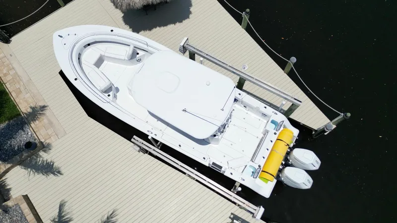  Yacht Photos Pics 2024 Sportsman 322 Open boat docked, aerial view, showcasing sleek design and twin engines.
