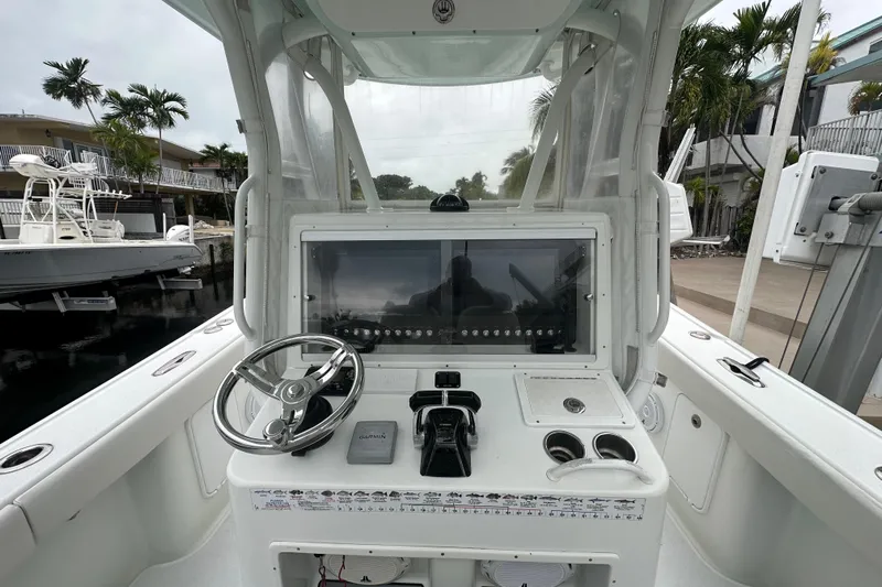  Yacht Photos Pics 2012 Yellowfin 32 Offshore boat cockpit with steering wheel and control panel.