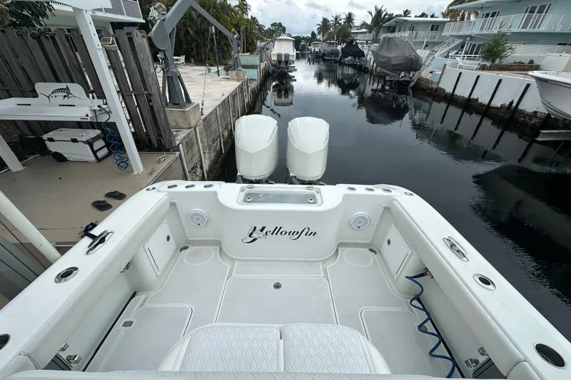  Yacht Photos Pics 2012 Yellowfin 32 Offshore boat docked in a serene canal setting.