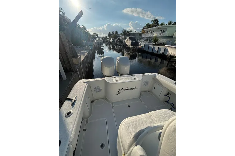  Yacht Photos Pics 2012 Yellowfin 32 Offshore boat docked in a scenic canal setting.