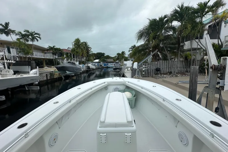  Yacht Photos Pics 2012 Yellowfin 32 Offshore boat docked in a tropical canal setting.