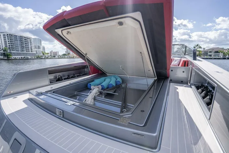 Warriors At Sea Yacht Photos Pics 2016 VanDutch 55 yacht with open storage compartment, docked by waterfront buildings.