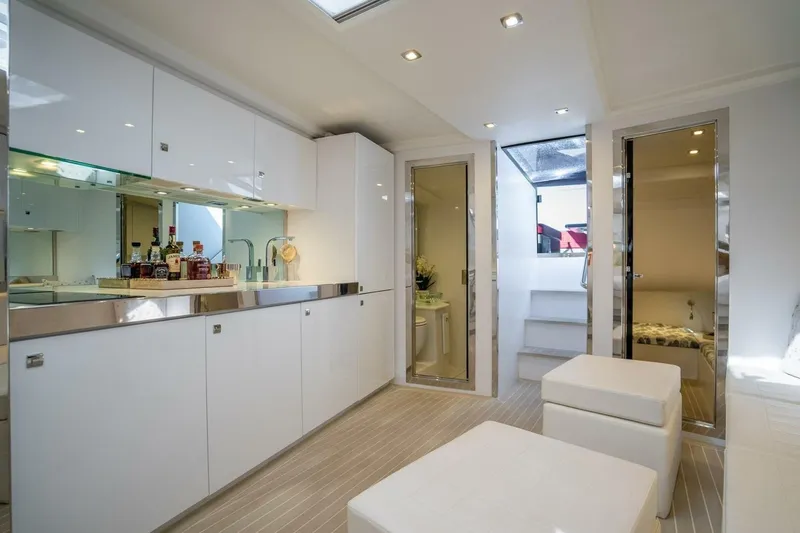 Warriors At Sea Yacht Photos Pics Luxurious interior of 2016 VanDutch 55 yacht with modern white cabinetry and seating.