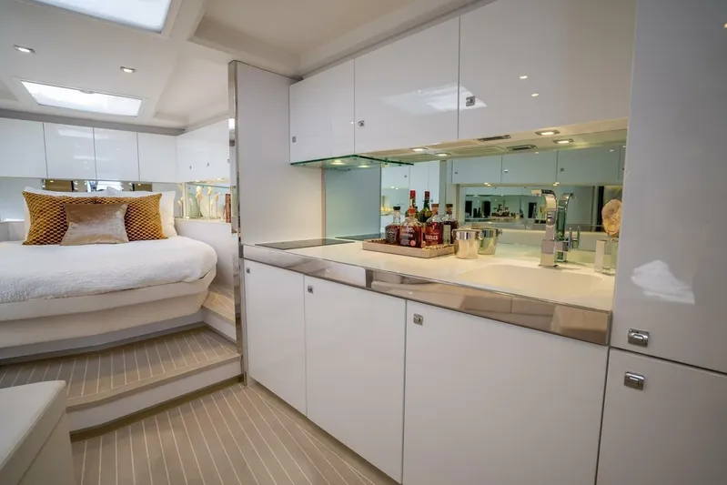 Warriors At Sea Yacht Photos Pics Luxurious interior of 2016 VanDutch 55 yacht with modern kitchen and cozy bedroom.