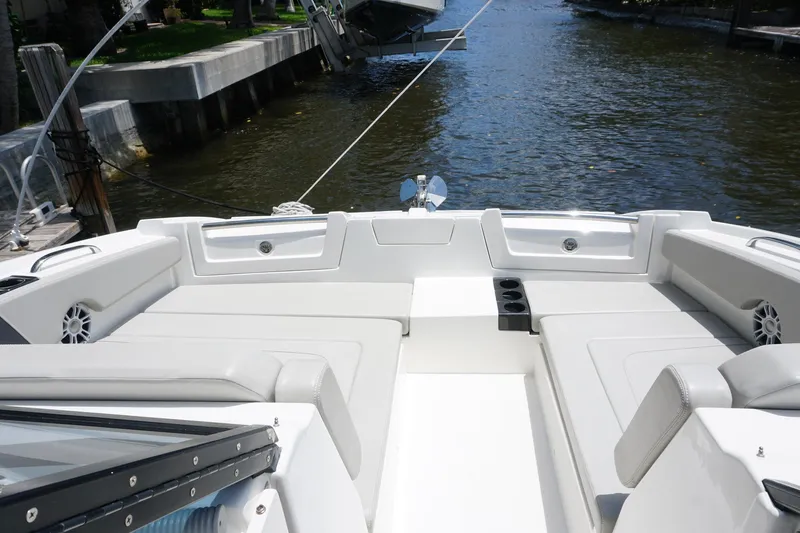 Sea)3 Yacht Photos Pics Aquila 32 Sport 2022 boat with spacious seating, docked by a serene waterfront.