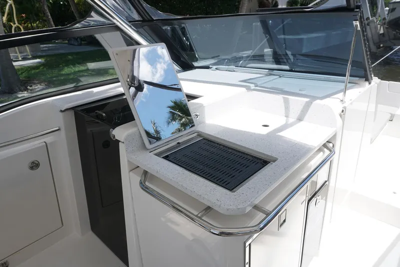 Sea)3 Yacht Photos Pics 2022 Aquila 32 Sport boat with sleek outdoor kitchen and grill setup.