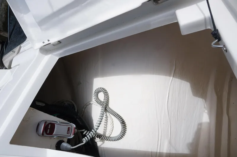 Sea)3 Yacht Photos Pics Storage compartment of 2022 Aquila 32 Sport boat with coiled cable and equipment.