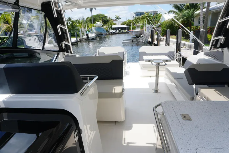 Sea)3 Yacht Photos Pics Aquila 32 Sport 2022 boat interior with modern seating and canal view.