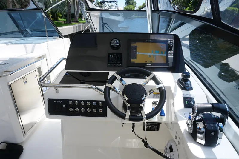 Sea)3 Yacht Photos Pics Helm of 2022 Aquila 32 Sport boat with modern navigation and control systems.