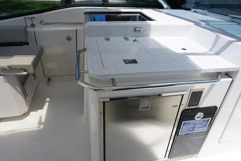 Sea)3 Yacht Photos Pics Aquila 32 Sport 2022 boat interior with kitchenette and stainless steel appliances.