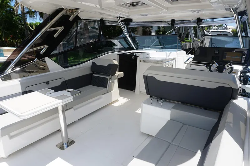 Sea)3 Yacht Photos Pics Interior of 2022 Aquila 32 Sport boat with modern seating and navigation area.