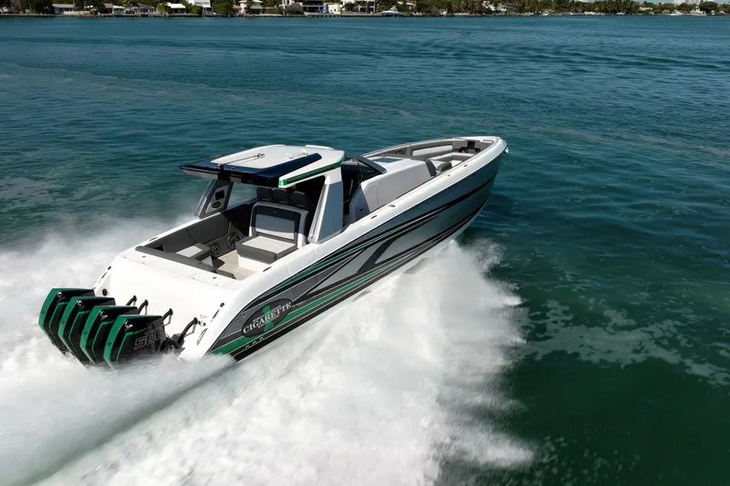  Yacht Photos Pics 2024 Cigarette 42' Auroris speedboat cruising on open water, showcasing sleek design and powerful engines.