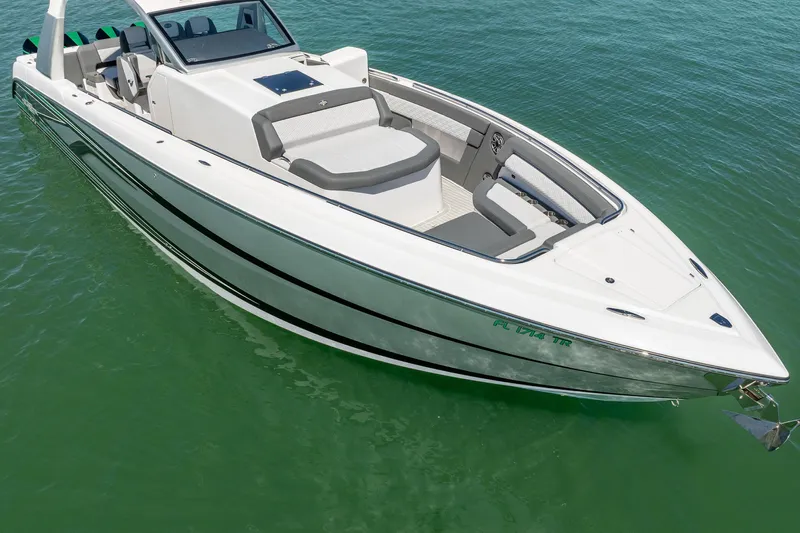  Yacht Photos Pics 2024 Cigarette 42' Auroris boat on clear green water, showcasing sleek design and luxury features.