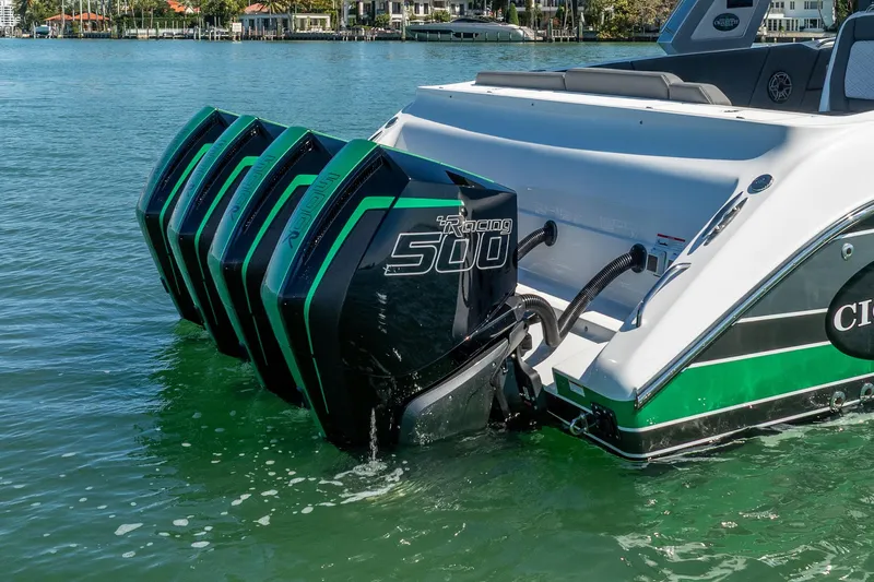  Yacht Photos Pics 2024 Cigarette 42' Auroris with quad outboard engines on a serene water backdrop.
