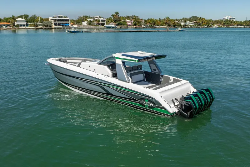  Yacht Photos Pics 2024 Cigarette 42' Auroris boat on calm water, showcasing sleek design and powerful engines.