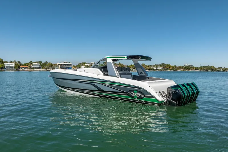  Yacht Photos Pics 2024 Cigarette 42' Auroris boat on calm water, showcasing sleek design and powerful engines.