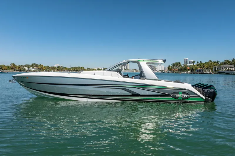  Yacht Photos Pics 2024 Cigarette 42' Auroris boat on calm water, sleek design, sunny day.