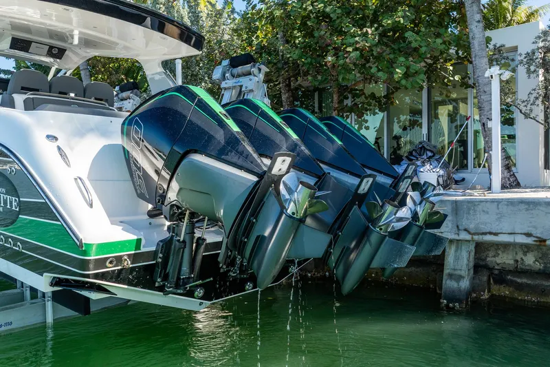  Yacht Photos Pics 2024 Cigarette 42' Auroris boat with powerful outboard engines docked by the water.