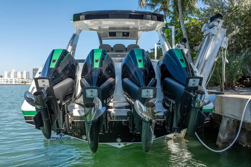  Yacht Photos Pics 2024 Cigarette 42' Auroris boat with four powerful outboard engines docked by the water.