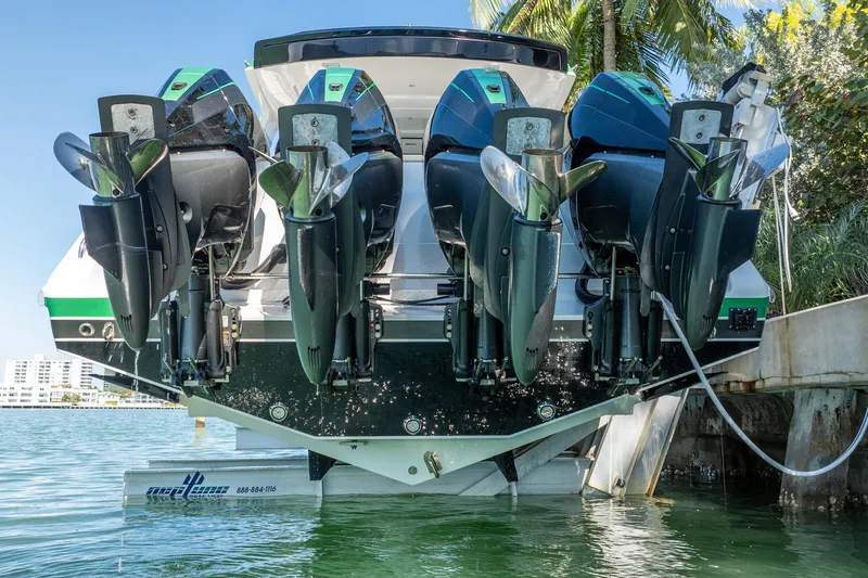  Yacht Photos Pics 2024 Cigarette 42' Auroris boat with multiple powerful outboard engines docked by the water.