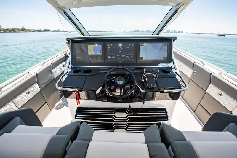  Yacht Photos Pics 2024 Cigarette 42' Auroris boat cockpit with advanced navigation screens and luxurious seating.