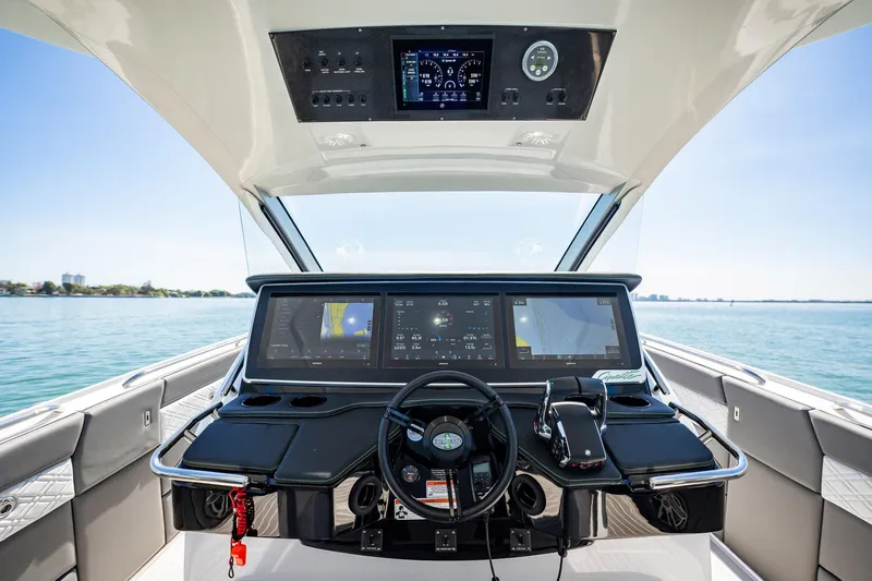  Yacht Photos Pics 2024 Cigarette 42' Auroris yacht cockpit with advanced navigation displays and steering wheel.