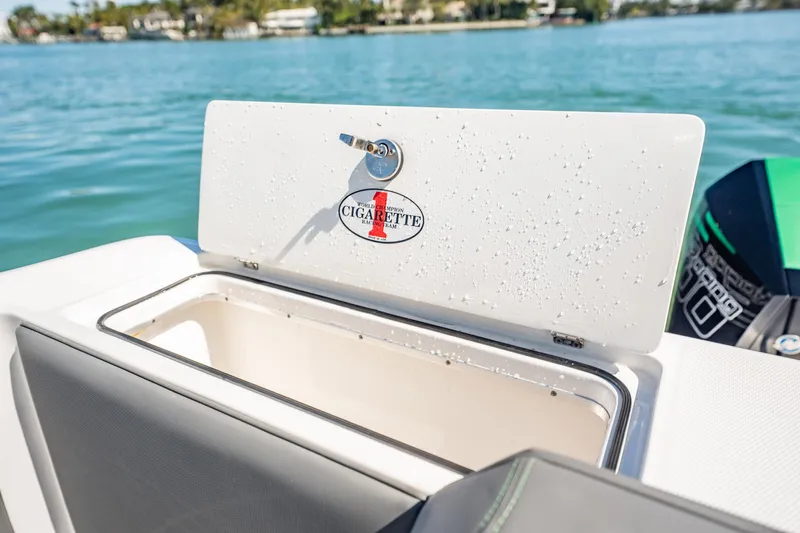  Yacht Photos Pics 2024 Cigarette 42' Auroris boat storage compartment with water droplets, open on a sunny day.