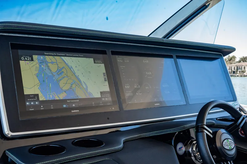  Yacht Photos Pics Dashboard of 2024 Cigarette 42' Auroris with advanced navigation screens and steering wheel.