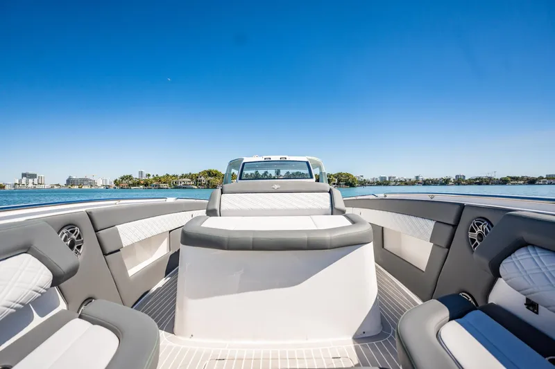  Yacht Photos Pics 2024 Cigarette 42' Auroris luxury boat interior with sleek seating and waterfront view.