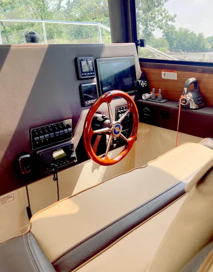 Seaburd Yacht Photos Pics Helm of 2018 Ranger Tugs R-29 S with wooden steering wheel and navigation controls.