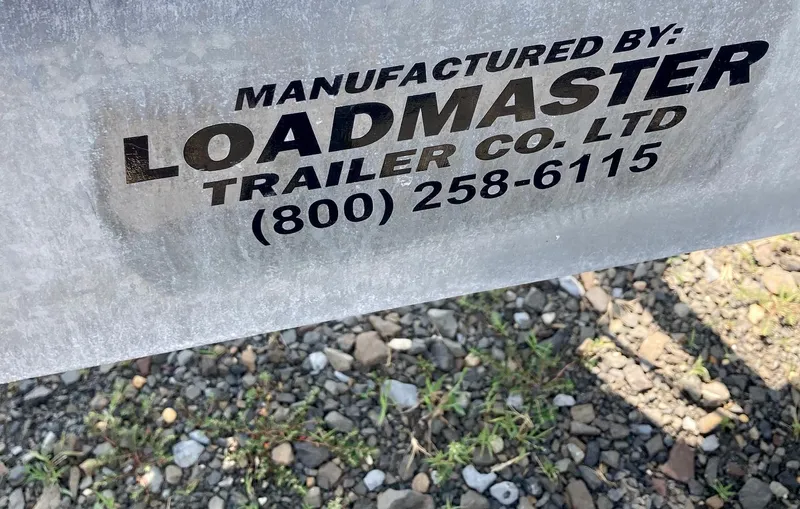 Seaburd Yacht Photos Pics Loadmaster Trailer Co. Ltd. label on metal surface, gravel background, Ranger Tugs R-29 S 2018.