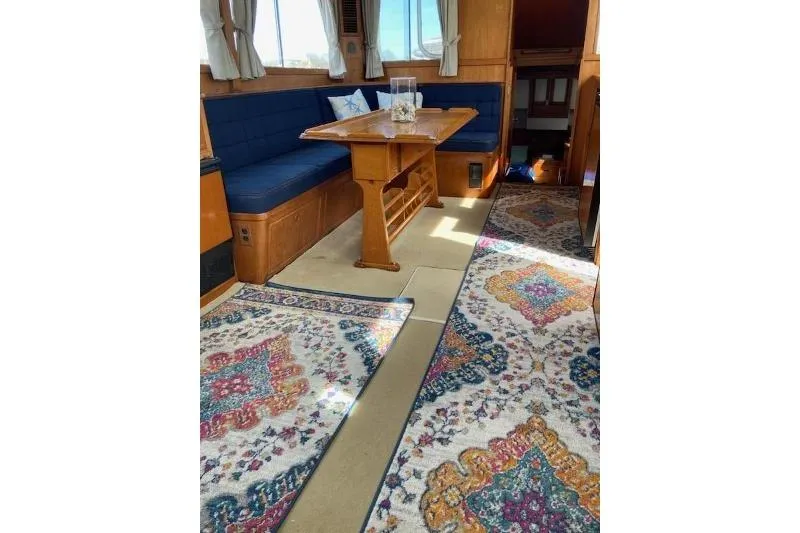 Burnin Daylight Yacht Photos Pics Interior of 1983 Grand Banks 42 Classic yacht with blue seating and patterned rugs.