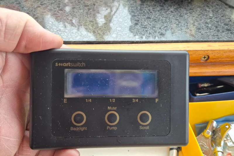 Burnin Daylight Yacht Photos Pics Hand holding a smartswitch control panel on a 1983 Grand Banks 42 Classic boat.