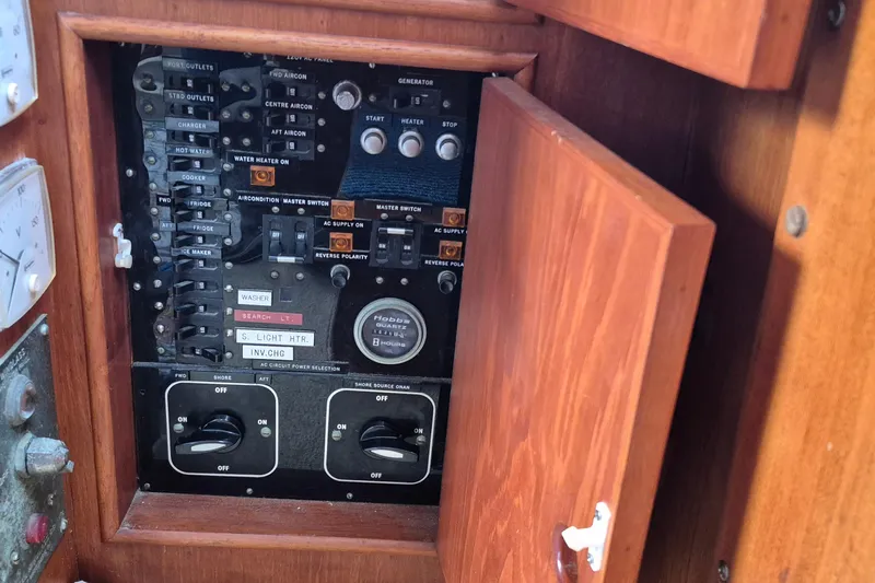 Burnin Daylight Yacht Photos Pics Electrical panel inside a 1983 Grand Banks 42 Classic yacht, featuring various switches and controls.