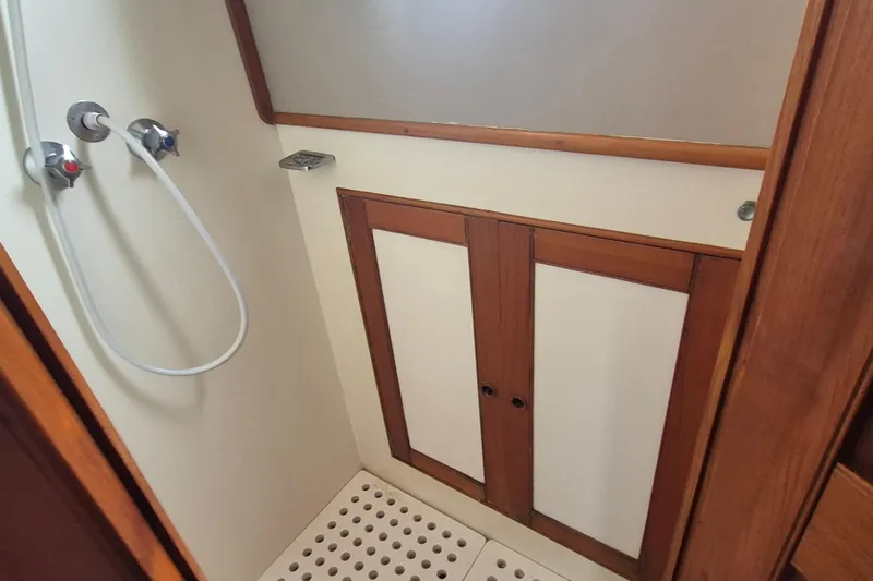 Burnin Daylight Yacht Photos Pics Shower area in 1983 Grand Banks 42 Classic yacht with wooden cabinetry.