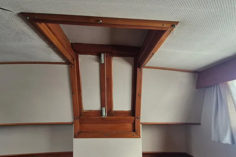 Burnin Daylight Yacht Photos Pics Interior view of 1983 Grand Banks 42 Classic boat with wooden trim and ceiling hatch.