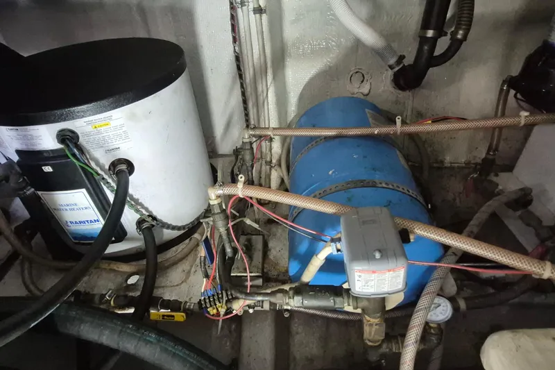 Burnin Daylight Yacht Photos Pics Engine room of 1983 Grand Banks 42 Classic with water heater and plumbing.