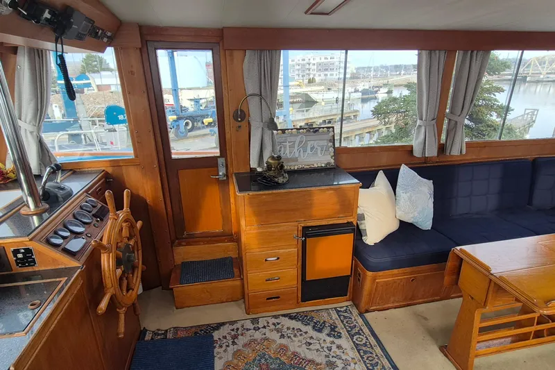 Burnin Daylight Yacht Photos Pics Interior of 1983 Grand Banks 42 Classic yacht with wooden helm and cozy seating area.