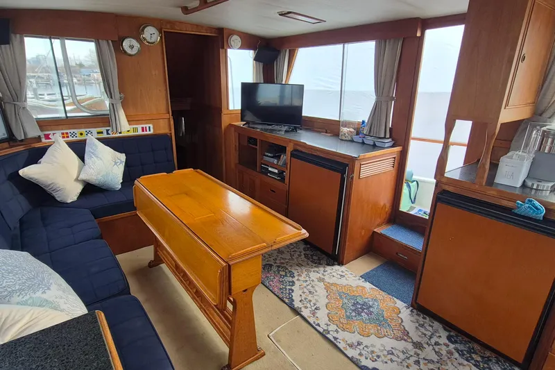 Burnin Daylight Yacht Photos Pics Interior of 1983 Grand Banks 42 Classic yacht with cozy seating and wooden furnishings.