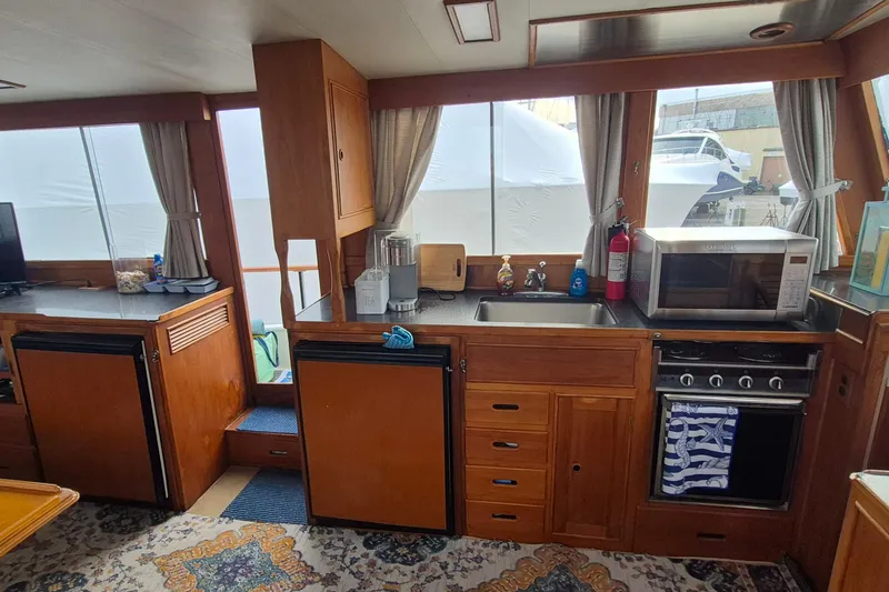 Burnin Daylight Yacht Photos Pics Interior of 1983 Grand Banks 42 Classic yacht kitchen with wooden cabinetry and appliances.