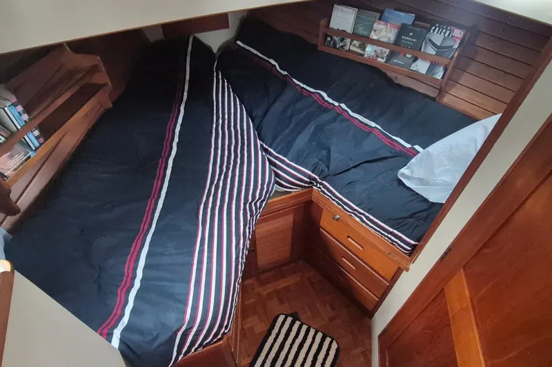 Burnin Daylight Yacht Photos Pics Cozy cabin interior of 1983 Grand Banks 42 Classic with twin beds and bookshelves.