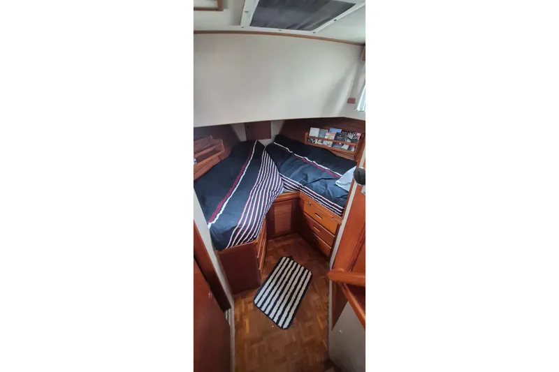 Burnin Daylight Yacht Photos Pics Cozy cabin interior of 1983 Grand Banks 42 Classic yacht with striped bedding.