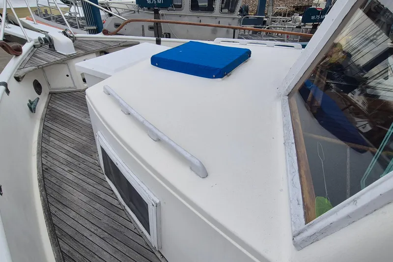 Burnin Daylight Yacht Photos Pics 1983 Grand Banks 42 Classic yacht deck with wooden flooring and blue hatch cover.